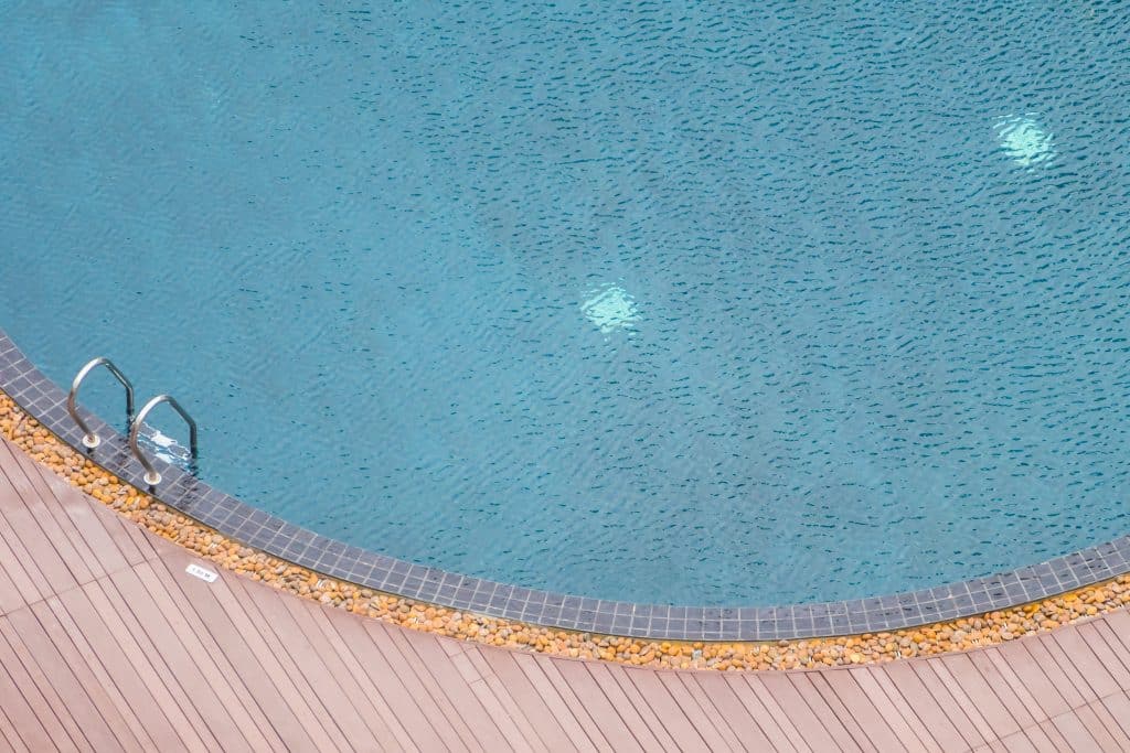 Staircase surrounding hotel resort swimming pool with lounge area