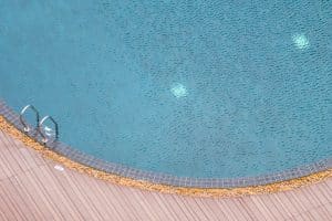 Staircase surrounding hotel resort swimming pool with lounge area